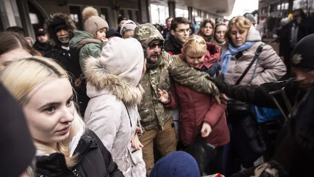 Ukrainian police try to prevent people storming onto a train as thousands of people continued to leave the country to flee to safety at the central train station in Kyiv, Ukraine on March 2,2022. (Photo by Heidi Levine for The Washington Post)