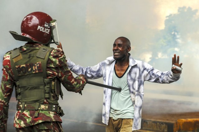 A protester reacts at an anti-riot police officer after being teargased as he takes part in a demonstration against a controversial tax bill in the central business district in Nairobi, Kenya, 20 June 2024. Police have fired tear gas to disperse protesters who gathered near the parliament to demonstrate against planned tax hikes that many fear will worsen the cost-of-living crisis. (Photo by Daniel Irungu/EPA)