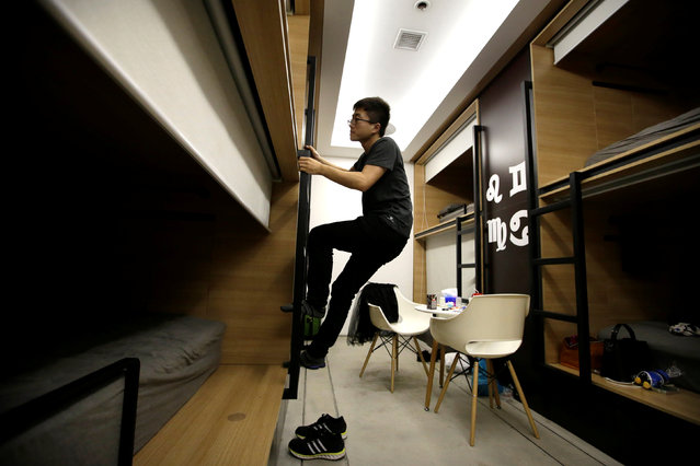 Du Xianchang, a R&D engineer at BaishanCloud, climbs up a ladder as he goes to bed in an individual sleeping quarter in the office after finishing work at midnight, in Beijing, China, April 27, 2016. (Photo by Jason Lee/Reuters)