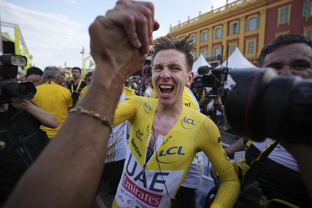 Tour de France winner Slovenia's Tadej Pogacar celebrates after the twenty-first stage of the Tour de France cycling race, an individual time trial over 33.7 kilometers (20.9 miles) with start in Monaco and finish in Nice, France, Sunday, July 21, 2024. (Photo by Laurent Cipriani/AP Photo)