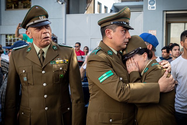 Chilean police officers cry for the murder of their co-worker, Daniel Palma, in Santiago on April 6, 2023. Palma was assassinated by unknown persons, during the early hours of this Thursday, April 6, in the midst of an audit. Palma's murder is the third of a police officer in the last 23 days. (Photo by Lucas Aguayo Araos/Anadolu Agency via Getty Images)