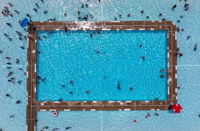 An aerial view of people cooling off from temperatures reaching close to 100 degrees at the Edward P. Thomas Jr. Memorial Swimming Pool at Baker Park in Frederick, Md., on Tuesday, July 9, 2024. (Photo by Ricky Carioti/The Washington Post)