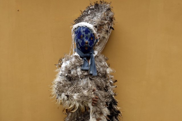 Francisco Solano poses for a photo in his bird-feather suit after attending a Mass commemorating the feast day of St. Francis Solano, in Emboscada, Paraguay, Friday, July 24, 2015. Some 500 people attended the festivity - a mix of indigenous and Guarani Indian beliefs. The festival begins with a Mass, continues with a procession of the diminutive wooden statue of St. Francis, and ends with people dancing in suits made with black, white, brown and grey feathers. (Photo by Jorge Saenz/AP Photo)