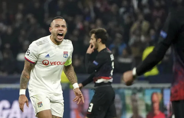 Lyon's Memphis Depay celebrates at the end of the match during the group G Champions League soccer match between Lyon and RB Leipzig at the Lyon Olympic Stadium in Decines, outside Lyon, France, Tuesday, December 10, 2019. (Photo by Laurent Cipriani/AP Photo)