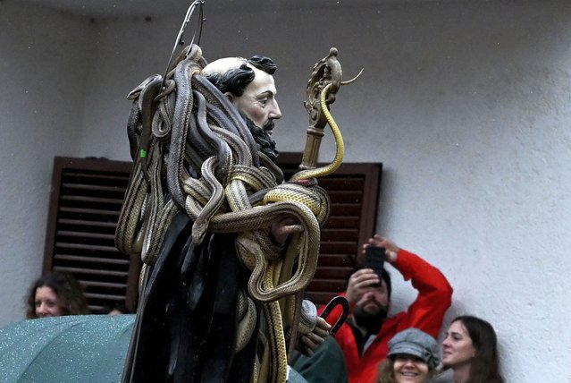 A statue of Saint Domenico covered with live snakes is carried by faithfuls during an annual procession in the streets of Cocullo, a small village in the Abruzzo region, on May 1, 2023. (Photo by Tiziana Fabi/AFP Photo)