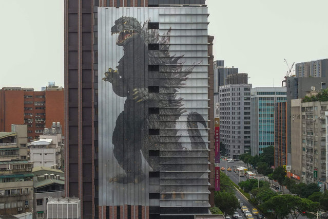 A giant Godzilla poster, which is almost 50 metres tall, is seen outside of a local hotel in Taipei on June 15, 2023. (Photo by Sam Yeh/AFP Photo)