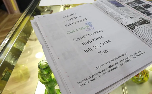 A full-page announcement that the grand opening of the Cannabis City recreational marijuana shop in Seattle will be held at “high noon” on Tuesday, July 8, 2014, is displayed Monday, July 7, 2014. The store will be the first and only store in Seattle to initially sell recreational marijuana when legal sales begin on Tuesday. (Photo by Ted S. Warren/AP Photo)