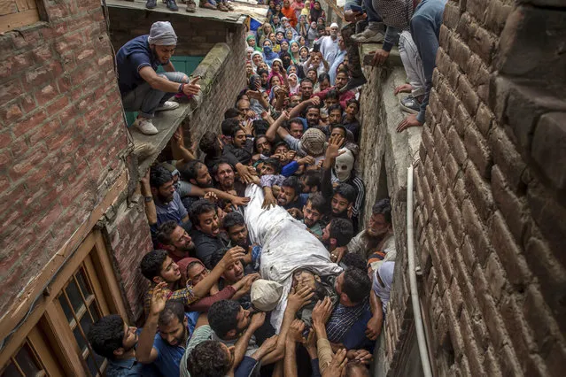 Kashmiris shout freedom slogans as they carry the body of a local rebel Sajad Ahmed Gilkar, during his funeral in Srinagar, Indian controlled Kashmir, Wednesday, July 12, 2017. Government forces fired shotgun pellets and tear gas Wednesday in the main city in Indian-controlled Kashmir as residents carried the body of the young rebel killed with two other militants during a gunbattle with Indian troops in the disputed region. (Photo by Dar Yasin/AP Photo)