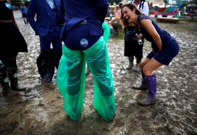 Members of the NHS Choir entertain themselves in the mud at Worthy Farm in Somerset during the Glastonbury Festival, Britain, June 25, 2016. (Photo by Stoyan Nenov/Reuters)