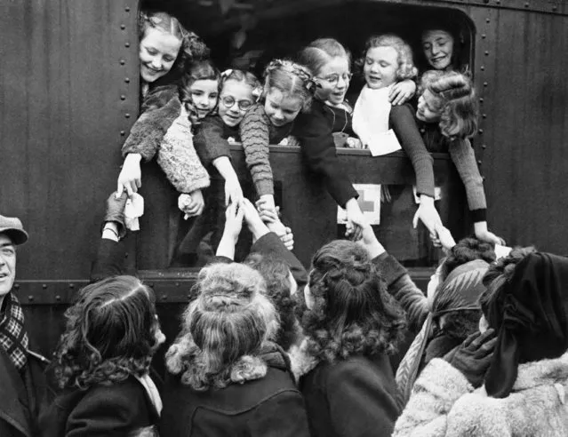 The first party of Belgian children are seen off by their parents at Brussels when they leave for a three months? recuperation period in Switzerland, July 15, 1945. They are being sent to recover from the effects of undernourishment and bombing during the enemy occupation, by the Belgian Red Cross. (Photo by AP Photo)