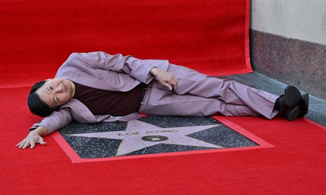 US actor Ken Jeong lies on his newly unveilled Star on thed Walk of Fame during his ceremony on October 23, 2024, in Hollywood. (Photo by Robyn Beck/AFP Photo)