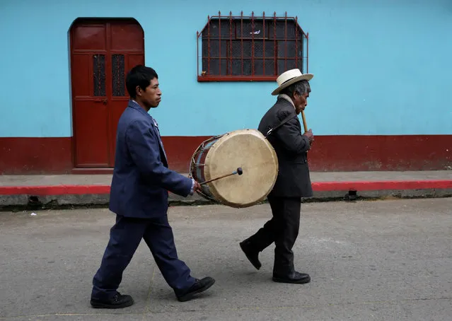 Musicians play their instruments during the annual procession honoring San Pedro, their town's patron saint, while they walk along the streets of San Pedro Sacatepequez near Guatemala City June 29, 2016. (Photo by Saul Martinez/Reuters)