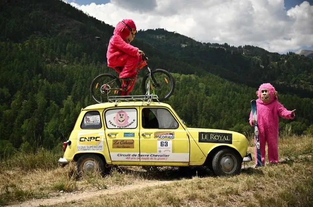 Spectators in costume line the race route during the 12th stage of the 109th edition of the Tour de France cycling race, 165,1 km between Briancon and L'Alpe-d'Huez, in the French Alps, on July 14, 2022. (Photo by Marco Bertorello/AFP Photo)