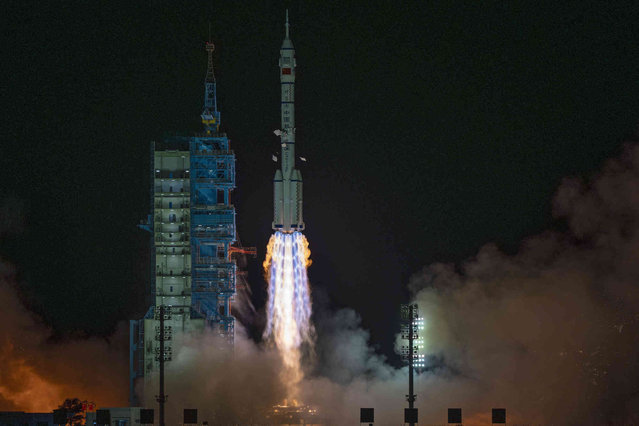 Shenzhou-19 spacecraft sitting atop a Long March rocket takes off from the Jiuquan Satellite Launch Center in Jiuquan, northwestern China in the early hours of Wednesday, October 30, 2024. (Photo by Ng Han Guan/AP Photo)