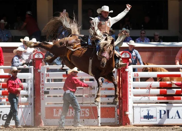 Jeret Cooper of Vernon, British Columbia rides the horse Einstein Quest in the novice bareback event during the Calgary Stampede rodeo in Calgary, Alberta, Canada on July 11, 2022. (Photo by Todd Korol/Reuters)