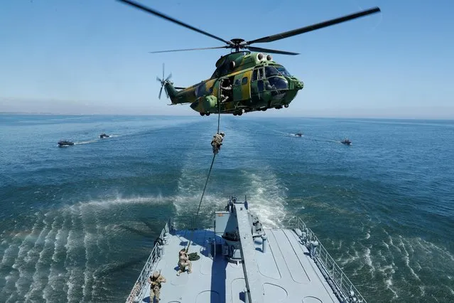 Romanian helicopter Puma 330 is seen as Romanian, British and U.S. maritime NATO forces carry out “Exercise Trojan Footprint” exercises during a media tour of the special operations at sea off Constanta, Romania, May 9, 2022. (Photo by Remo Casilli/Reuters)