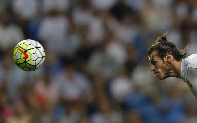 Real Madrid's Gareth Bale heads the ball to score the opening goal against Real Betis during a Spanish La Liga soccer match between Real Madrid and Real Betis at the Santiago Bernabeu stadium in Madrid, Saturday, August 29, 2015. (Photo by Francisco Seco/AP Photo)