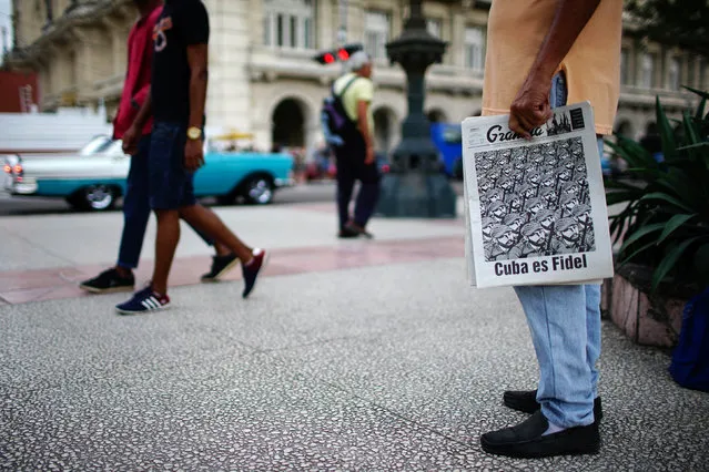 A man sells the Cuban Communist Party (PCC) official newspaper Granma which reads: “Cuba is Fidel”, in Havana, Cuba, January 13, 2017. (Photo by Alexandre Meneghini/Reuters)