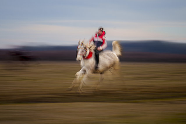 A man participates in a traditional horse race during Epiphany celebrations in the village of Pietrosani, Romania, Monday, January 6, 2025. (Photo by Andreea Alexandru/AP Photo)