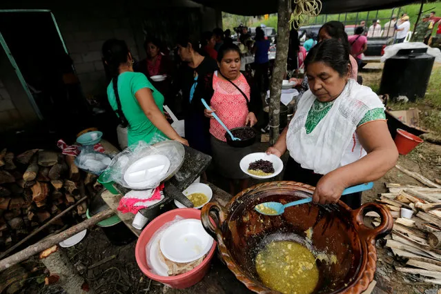 Residents receive food at a shelter after a mudslide, in the aftermath of Tropical Storm Earl in the town of San Miguel Xaltepec, in Puebla state, Mexico, August 8, 2016. (Photo by Henry Romero/Reuters)