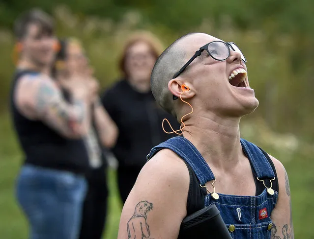 In this October 8, 2017, photo, Emily Lynch reacts to hitting her first clay target during a training session for the Trigger Warning Queer & Trans Gun Club in Victor, N.Y. A gay, lesbian and transgender group concerned that extremists have become more emboldened and dangerous have decided to take up arms. The gun club meets once a month to shoot long guns in a field in upstate New York. (Photo by Adrian Kraus/AP Photo)