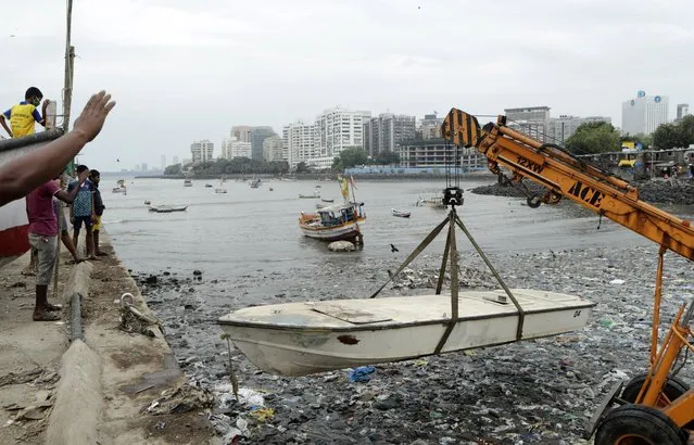 Fishermen relocate a boat as part of precautions against cyclone on the Arabian Sea coast in Mumbai, India, Tuesday, June 2, 2020. Cyclone Nisarga in the Arabian Sea was barreling toward India's business capital Mumbai on Tuesday, threatening to deliver high winds and flooding to an area already struggling with the nation's highest number of coronavirus infections and deaths. (Photo by Rajanish Kakade/AP Photo)