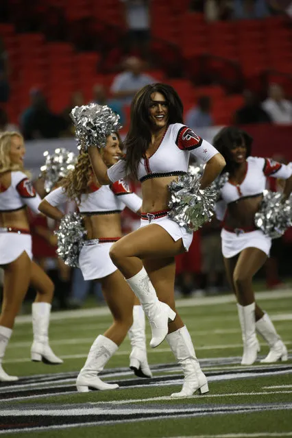 Atlanta Falcons cheerleaders perform before the first half of an NFL preseason football game against the Miami Dolphins, Friday, August 8, 2014, in Atlanta. (Photo by John Bazemore/AP Photo)