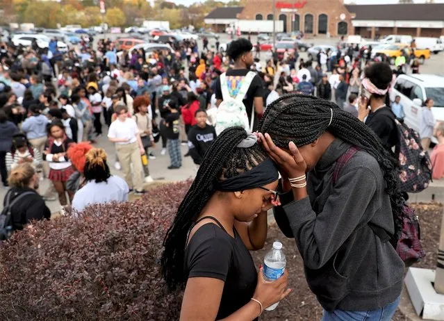 Students stand in a parking lot near the Central Visual & Performing Arts High School after a reported shooting at the school in St. Louis on Monday, October 24, 2022. (Photo by David Carson/St. Louis Post-Dispatch via AP Photo)