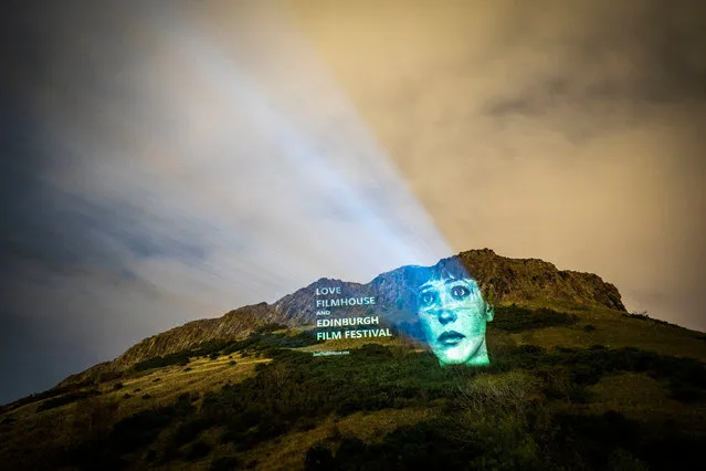 An image of Danish-French actress Anna Karina, from the film “Vivre Sa Vie” projected on Salisbury Crags in Edinburgh on Monday, October 31, 2022, is one of several classic movie images projected onto landmarks and public buildings in the city as part of the campaign to save the Edinburgh International Film Festival and the Filmhouse. (Photo by Jane Barlow/PA Images via Getty Images)