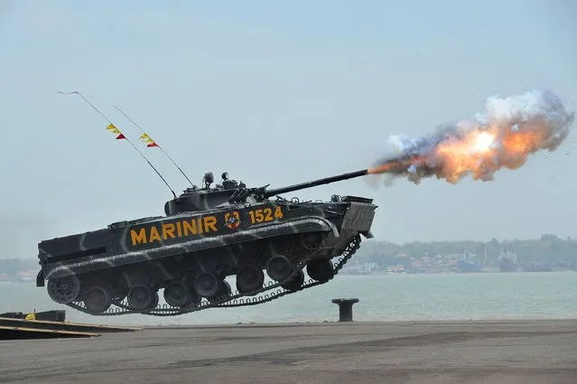 An Indonesian Marine tank jumps and launches missiles during The 69th Republic of Indonesian Military Anniversary on October 7, 2014 in Surabaya, Indonesia. The 69th Republic of Indonesian Military Anniversary will be the last led by Republic of Indonesia President Susilo Bambang Yudhoyono (SBY). This year's ceremony will be the biggest for the past ten years with the Indonesian Army, Navy, and Air Force all taking part. (Photo by Robertus Pudyanto/Getty Images)