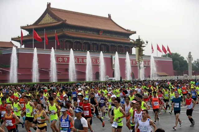 Participants run past the Tiananmen gate during the Beijing International Marathon in Beijing, China, September 20, 2015. (Photo by Kim Kyung-Hoon/Reuters)
