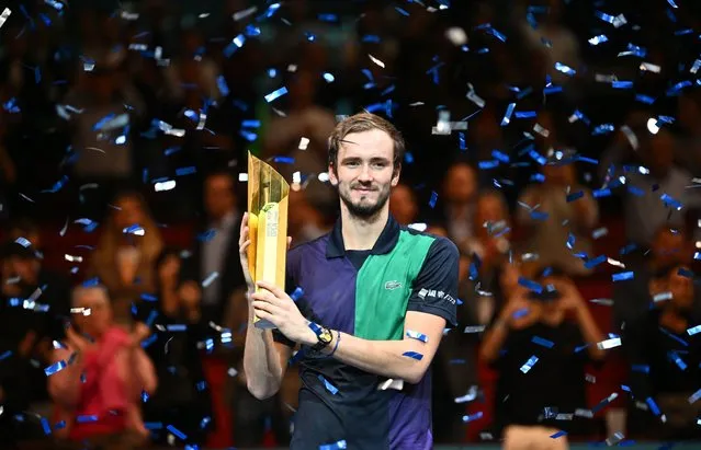 Russia's Daniil Medvedev holds the trophy as he celebrates his victory over Canada's Denis Shapovalov after the final match of the ATP Vienna Open tennis tournament in Vienna, Austria, on October 30, 2022. (Photo by Joe Klamar/AFP Photo)