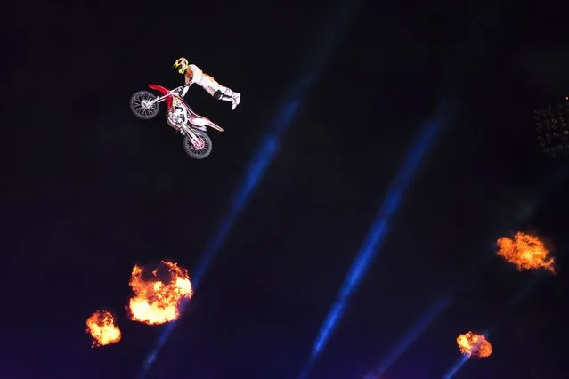 A rider performs motorcycle stunts during a Motor-Extreme show in the southern city of Ashkelon October 13, 2014. Six competitive riders from the United States took part in the show. (Photo by Amir Cohen/Reuters)