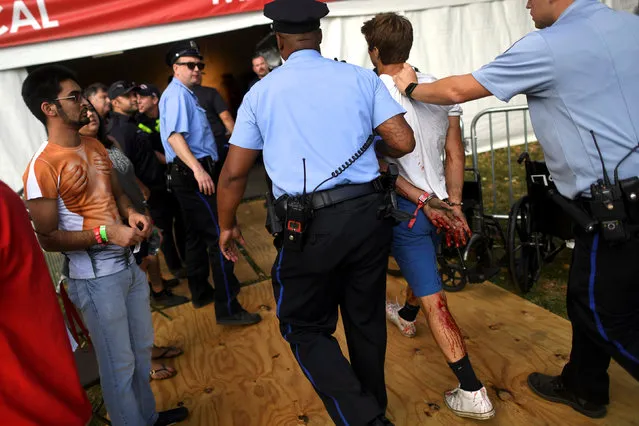 A bloodied man is detained during the fifth annual Made in America Music Festival in Philadelphia, Pennsylvania September 3, 2016. (Photo by Mark Makela/Reuters)