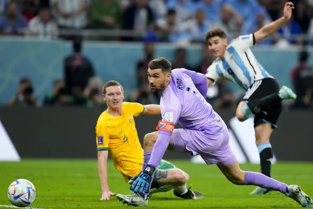 Australia's goalkeeper Mathew Ryan, center, fails to stop Argentina's Julian Alvarez from scoring his side's second goal during the World Cup round of 16 soccer match between Argentina and Australia at the Ahmad Bin Ali Stadium in Doha, Qatar, Saturday, December 3, 2022. (Photo by Petr David Josek/AP Photo)