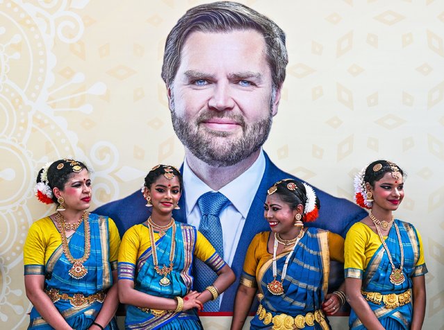 Dancers wearing traditional attire stand in front of a poster depicting US Vice President JD Vance upon his arrival on April 21, 2025 in New Delhi, India. Vance will hold talks with Prime Minister Narendra Modi as India attempts to boosts ties with the Trump administration and avoid steep U.S. tariffs. (Photo by Kenny Holston-Pool/Getty Images)
