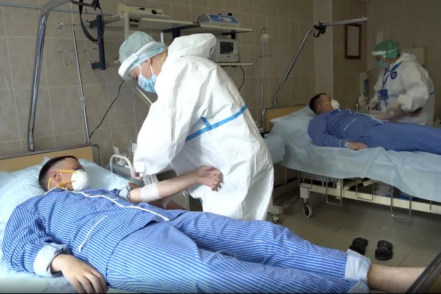 In this photo made from footage provided by the Russian Defense Ministry on Wednesday, July 15, 2020, medical workers in protective gear prepare to draw blood from volunteers participating in a trial of a coronavirus vaccine at the Budenko Main Military Hospital outside Moscow, Russia. Russia is boasting that it’s about to be the first country to approve a COVID-19 vaccine, but scientists worldwide are sounding the alarm that the headlong rush could backfire. (Photo by Russian Defense Ministry Press Service via AP Photo)