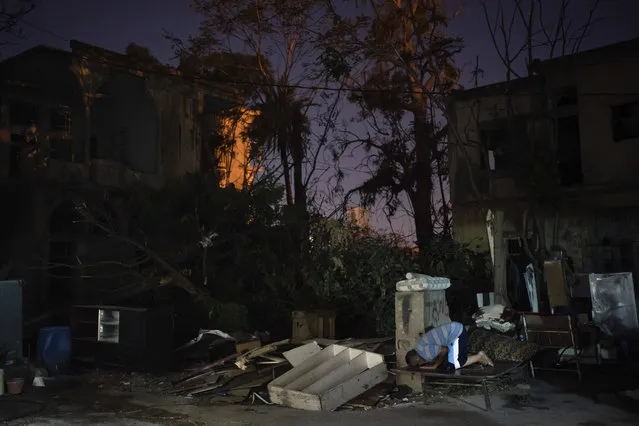 Mohammed Moussa prays on a makeshift bed outside his home, destroyed in the Aug. 4 explosion, in Beirut, Lebanon, on Sunday, August 16, 2020. (Photo by Felipe Dana/AP Photo)