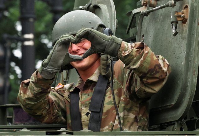 A soldier makes a “heart hands” gesture from inside a tank during the parade in Washington on June 14, 2025. (Photo by Kevin Mohatt/Reuters)