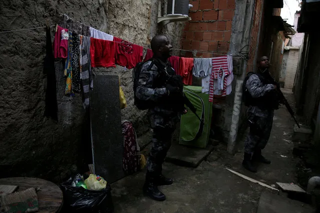 Military police officers patrol the Kelson's slum during an operation against crime in Rio de Janeiro, Brazil, Tuesday, February 20, 2018. (Photo by Pilar Olivares/Reuters)