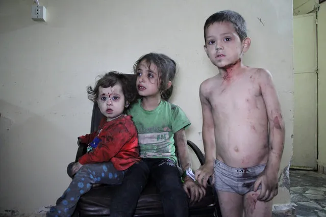 Wounded Syrian children await to receive treatment at a hospital following a reported air strike on the rebel-held northwestern city of Idlib on September 29, 2016. Numerous doctors and nurses and medical facilities have been hit or targeted by missiles or air strikes since the start of the conflict in Syria in March 2011. (Photo by Omar Haj Kadour/AFP Photo)