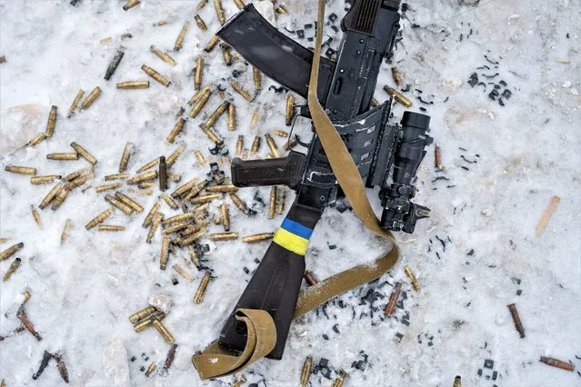 A rifle and empty shells are seen at a shooting range, amid Russia's attack on Ukraine, in Siversk, Donetsk region, Ukraine on February 18, 2023. (Photo by Marko Djurica/Reuters)