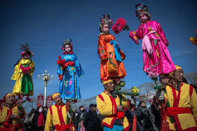 Chinese folk artists perform during a parade celebrating the upcoming traditional Lantern Festival in Yu County of Zhangjiakou city in Hebei province, China, 01 March 2018. China will celebrate the traditional Lantern Festival on 02 March, marking the end of the lunar new year celebrations and is traditionally celebrated by viewing lanterns and guessing lantern riddles. (Photo by Roman Pilipey/EPA/EFE)