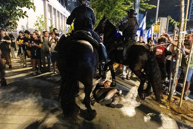 Protesters clash with police officers during a demonstration on May 25, 2024 in Tel Aviv, Israel. Demonstrators gathered to call for an hostage deal and to protest against Israeli Prime Minister Benjamin Netanyahu and his government. Negotiations over a ceasefire deal that would halt the war in Gaza are once again stalled, while Israel appears to be preparing for an expanded ground offensive around Rafah, despite international concern.(Photo by Amir Levy/Getty Images)