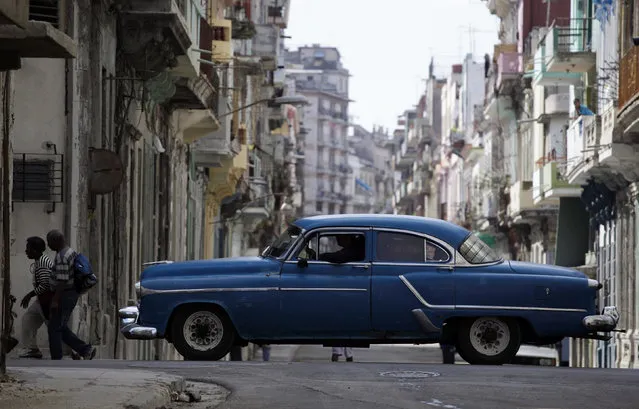 People walk past a Chevrolet Styleline 1952 model in Havana, February 15, 2010. (Photo by Desmond Boylan/Reuters)
