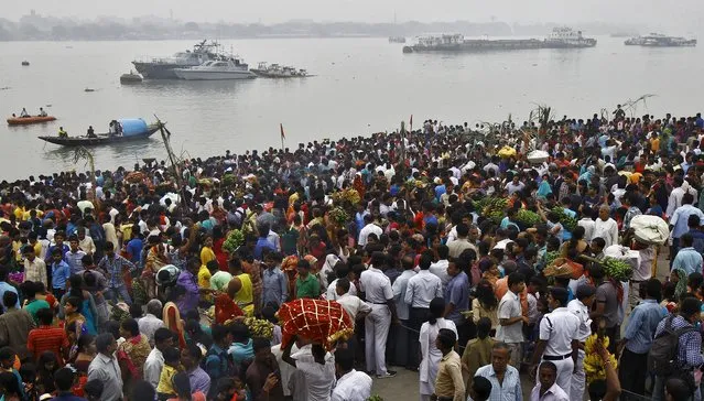 Hindu devotees gather on the banks of river Ganga to perform rituals to the Sun god Surya during the Hindu religious festival of Chatt Puja in Kolkata, India, November 17, 2015. (Photo by Rupak De Chowdhuri/Reuters)