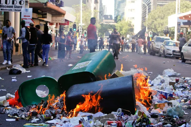 Rubbish burns after students protested outside the parliament during South African Finance Minister Pravin Gordhan's medium term budget speech in Cape Town, South Africa October 26, 2016. (Photo by Wayne Conradie/Reuters)