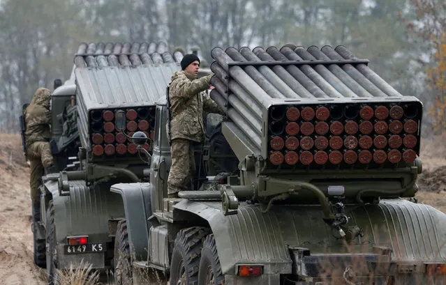 Ukrainian servicemen are seen atop BM-21 Grad multiple rocket launcher systems during military exercises near the village of Divychky in Kiev region, Ukraine, October 28, 2016. (Photo by Valentyn Ogirenko/Reuters)