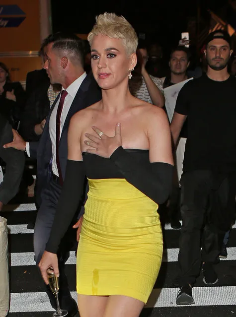 Katy Perry pictured crossing the street walking towards her hotel from the Met Gala after party with a glass of champagne in her hand in New York City on May 08, 2018. (Photo by Andrew Rocke/Splash News and Pictures)