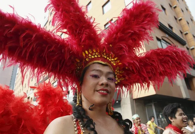 A Filipino transgender woman wears a headdress during a World Aids day celebration in Manila, Philippines, December 1, 2015. (Photo by Erik De Castro/Reuters)